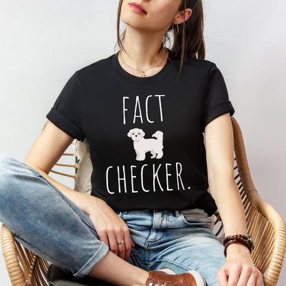 "Fact Checker" Maltese Dog T-Shirt for Unisex with a cute graphic of a Maltese dog and playful "Fact Checker" text underneath. Ideal for dog lovers. Ideal for dog lovers with a sense of humor. Available in multiple colors and sizes. Bella+Canvas 3001 t-shirt in black. ReadyShirtAim.com