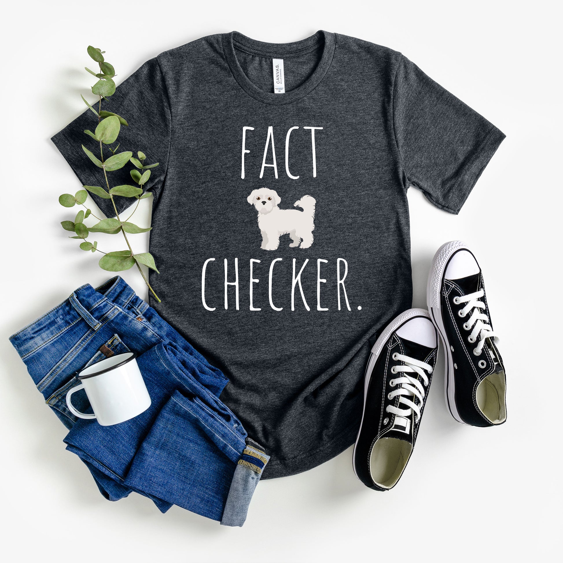 "Fact Checker" Maltese Dog T-Shirt for Unisex with a cute graphic of a Maltese dog and playful "Fact Checker" text underneath. Ideal for dog lovers. Ideal for dog lovers with a sense of humor. Available in multiple colors and sizes. Bella+Canvas 3001 t-shirt in dark grey heather. ReadyShirtAim.com