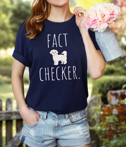 "Fact Checker" Maltese Dog T-Shirt for Unisex with a cute graphic of a Maltese dog and playful "Fact Checker" text underneath. Ideal for dog lovers. Ideal for dog lovers with a sense of humor. Bella+Canvas 3001 t-shirt in navy. ReadyShirtAim.com