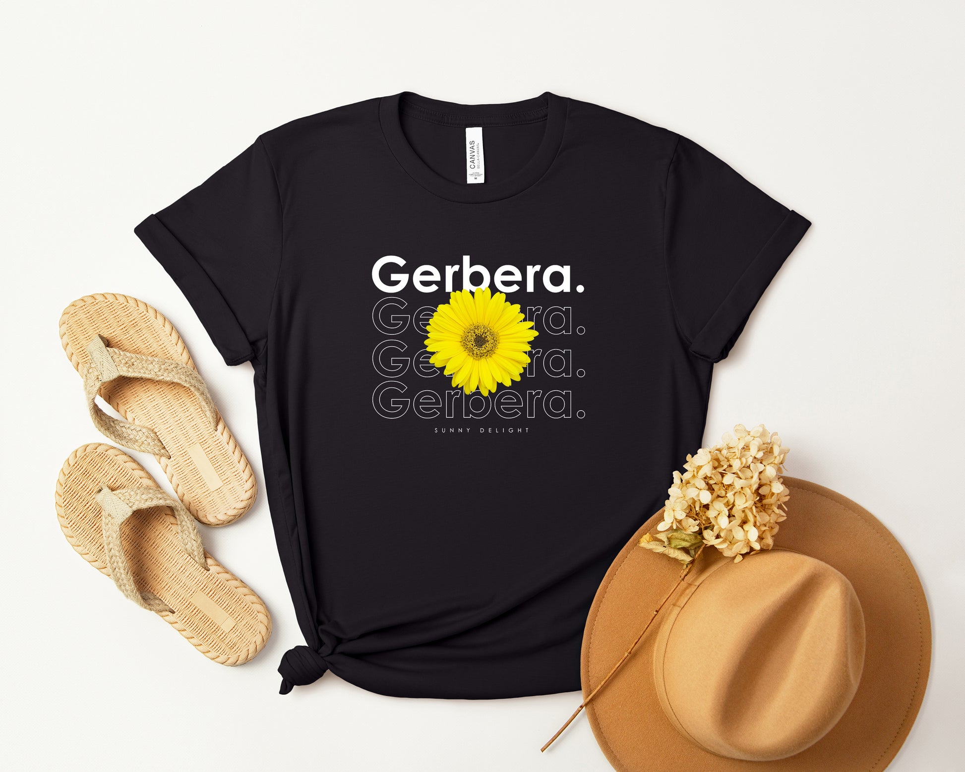 A photo-realistic yellow on yellow gerbera t-shirt with a bold contemporary floral design and the caption "Sunny Delight." Perfect for gerbera lovers, botanical enthusiasts, and nature lovers. Bella+Canvas 3001 t-shirt in black. ReadyShirtAim.com