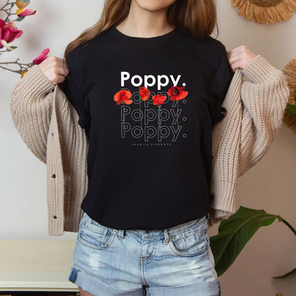 A photo-realistic red poppy t-shirt with a bold contemporary floral design and the caption "Fragile Strength." Perfect for poppy lovers, botanical enthusiasts, and nature lovers. Bella+Canvas 3001 t-shirt in black. ReadyShirtAim.com