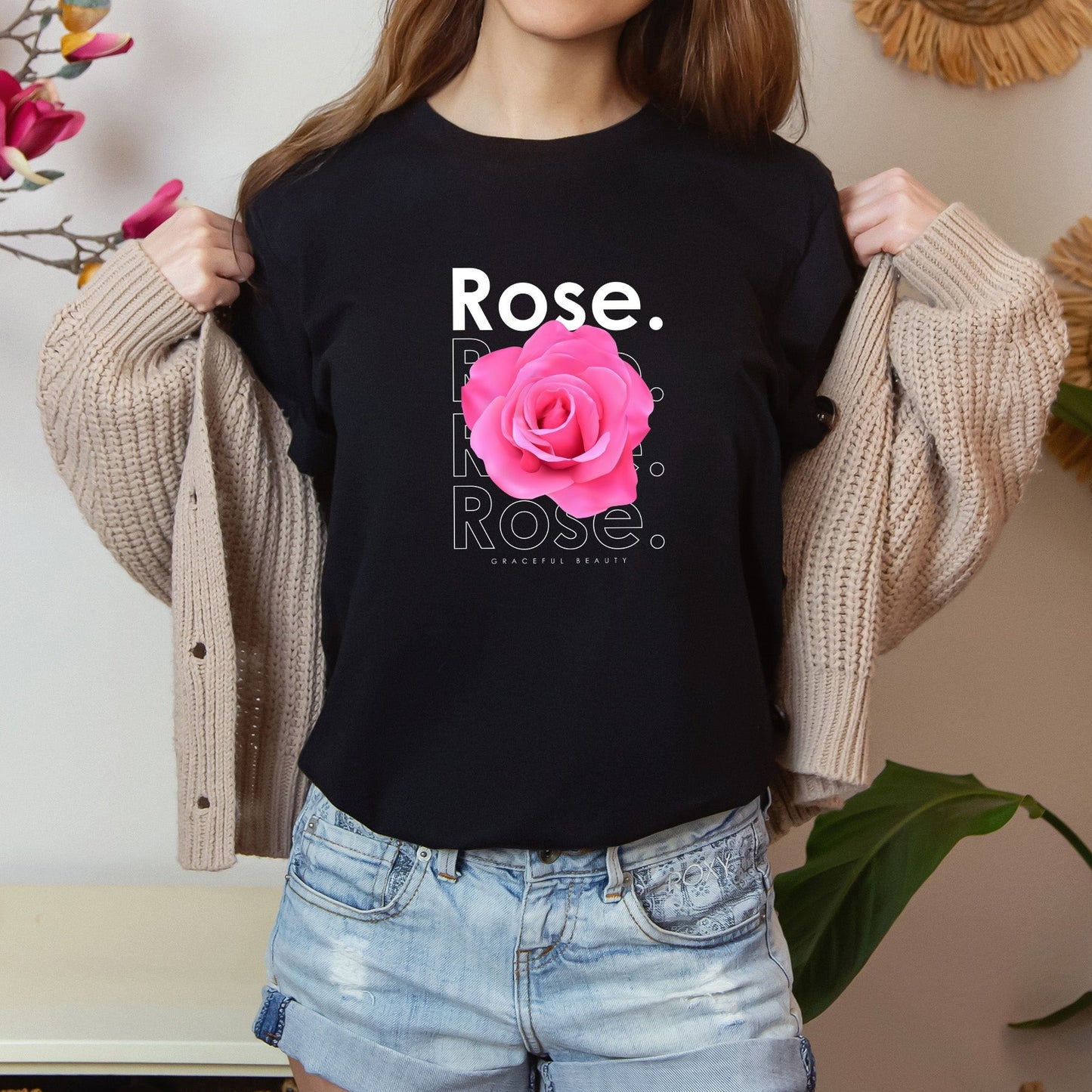 A t-shirt featuring a beautiful pink photo-realistic rose with the theme 'Graceful Beauty.' Perfect for those who adore floral art and nature. Comfortable and stylish for casual outings or celebrations. Bella+Canvas 3001 t-shirt in black. ReadyShirtAim.com