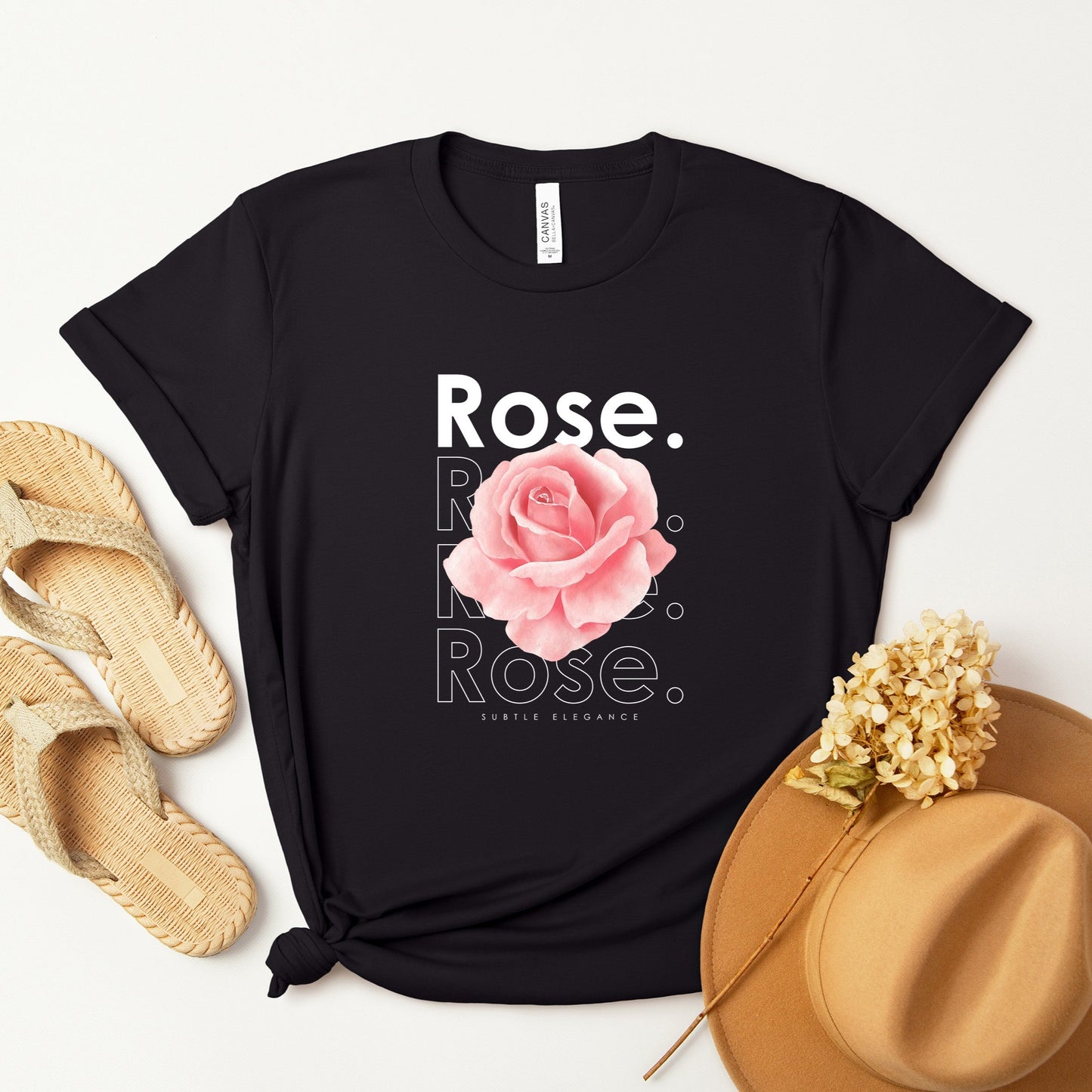 A t-shirt featuring a beautiful pale pink watercolor rose with the theme 'Subtle Elegance.' Perfect for those who adore floral art and nature. Comfortable and stylish for casual outings or celebrations. Bella+Canvas 3001 t-shirt in black. ReadyShirtAim.com