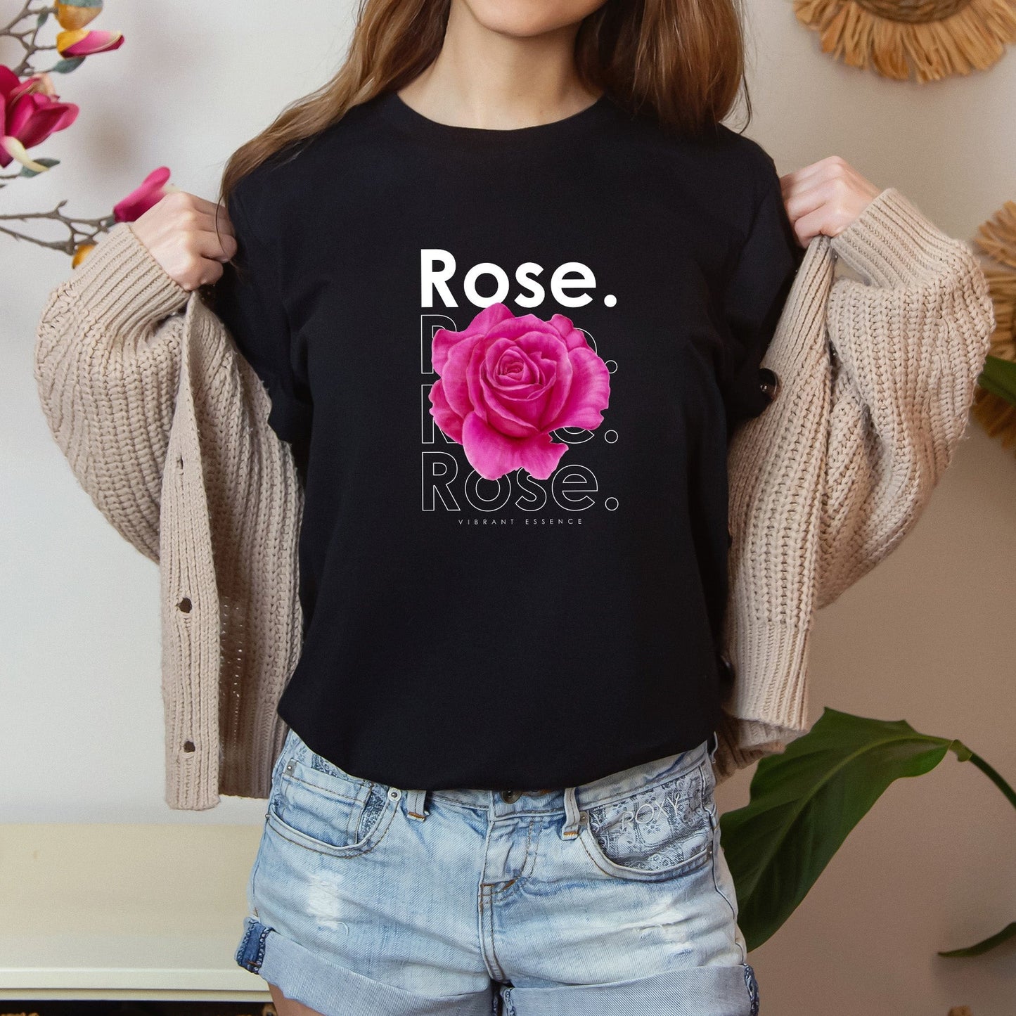 A t-shirt featuring a stunning bright pink watercolor rose with the theme 'Vibrant Essence.' Perfect for those who adore bold floral art and nature. Comfortable and stylish for casual outings or celebrations. Bella+Canvas 3001 t-shirt in black. ReadyShirtAim.com