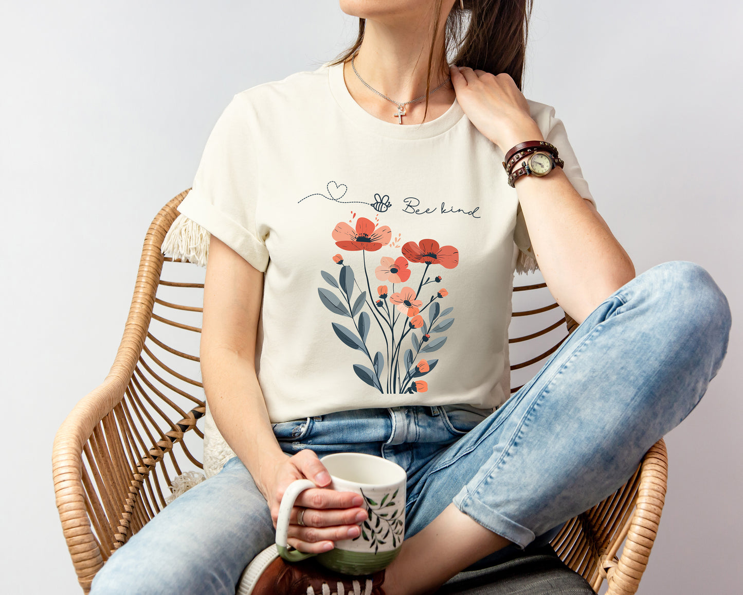 A Boho Scandinavian floral t-shirt with a simple flower design and the caption "Bee Kind." Perfect for compassionate souls, garden lovers, and nature enthusiasts. Bella+Canvas 3001 t-shirt in natural. ReadyShirtAim.com