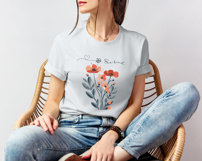 A Boho Scandinavian floral t-shirt with a simple flower design and the caption "Bee Kind." Perfect for compassionate souls, garden lovers, and nature enthusiasts. Bella+Canvas 3001 t-shirt in silver. ReadyShirtAim.com