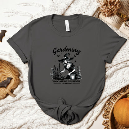 "Gardening, Because Murder is Wrong" Vintage 1950's Witch Halloween Women's T-Shirt featuring bold black text and a classic black-and-white image of a pin-up girl in a witch costume tending to flowers in a garden, smiling innocently, perfect for adding a retro touch with a playful twist to your Halloween festivities. Available in multiple colors and sizes.  Bella+Canvas 3001 t-shirt in asphalt. ReadyShirtAim.com