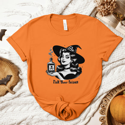 "Pick Your Poison" Vintage 1950's Witch Halloween Women's T-Shirt featuring bold black text and a classic black-and-white image of a pin-up girl in a sexy witch costume, gazing at a large, steaming potion bottle with a skull and crossbones on it, perfect for adding a retro touch with mystical charm to your Halloween festivities. Available in multiple colors and sizes.  Bella+Canvas 3001 t-shirt in orange. ReadyShirtAim.com